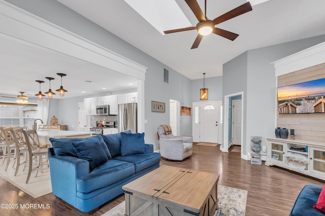 living room featuring dark hardwood / wood-style flooring, sink, and ceiling fan