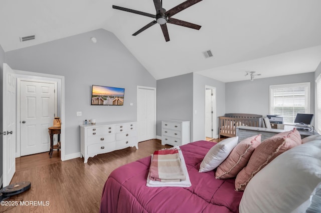 bedroom featuring vaulted ceiling, dark hardwood / wood-style floors, and ceiling fan