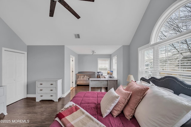 bedroom featuring ceiling fan, lofted ceiling, dark hardwood / wood-style flooring, and a closet