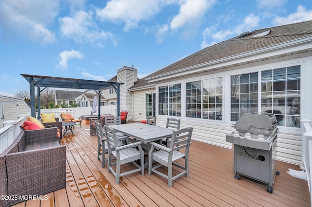 wooden terrace featuring area for grilling and a pergola