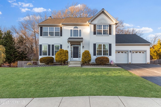 view of front of house with a garage and a front yard