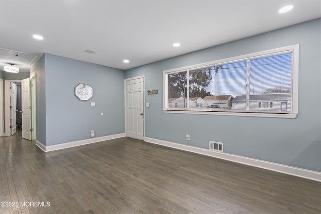 empty room featuring dark wood-type flooring