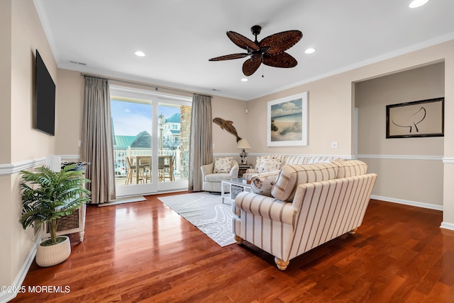 living room with ornamental molding, dark hardwood / wood-style floors, and ceiling fan