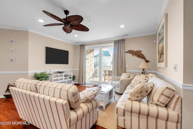 living room with hardwood / wood-style floors, ornamental molding, and ceiling fan