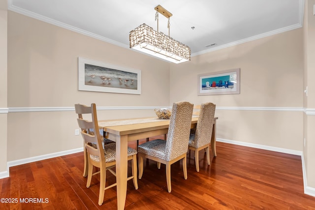 dining space featuring hardwood / wood-style floors and ornamental molding