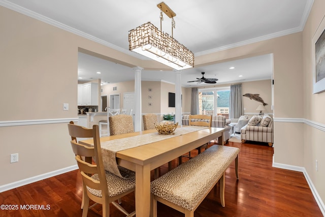 dining room featuring ornate columns, crown molding, dark wood-type flooring, and ceiling fan