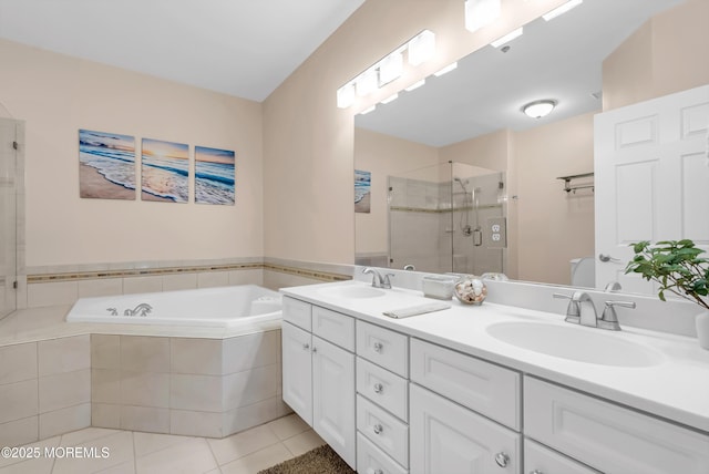 bathroom featuring tile patterned flooring, vanity, and separate shower and tub