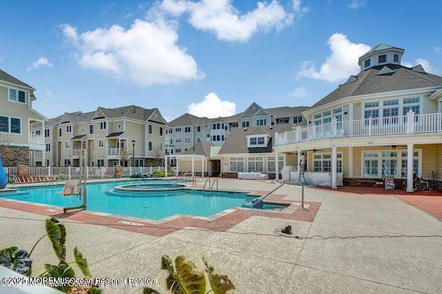 view of swimming pool featuring a patio and a community hot tub