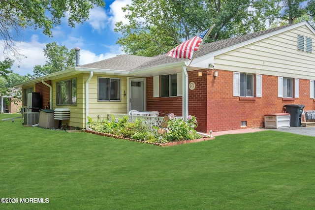 view of front facade with central AC unit and a front yard