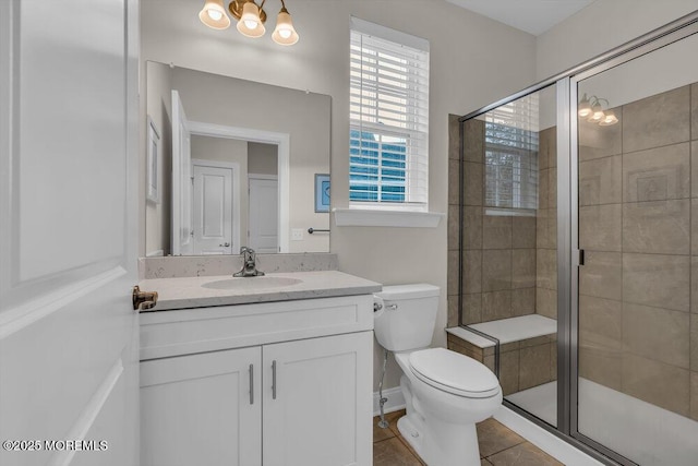 bathroom with a chandelier, vanity, an enclosed shower, toilet, and tile patterned floors