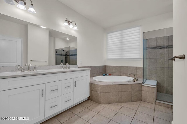 bathroom featuring tile patterned floors, shower with separate bathtub, and vanity