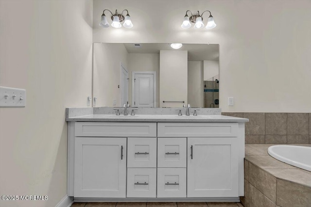 bathroom featuring vanity and independent shower and bath