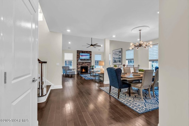 dining room with lofted ceiling, dark hardwood / wood-style flooring, a fireplace, and a healthy amount of sunlight