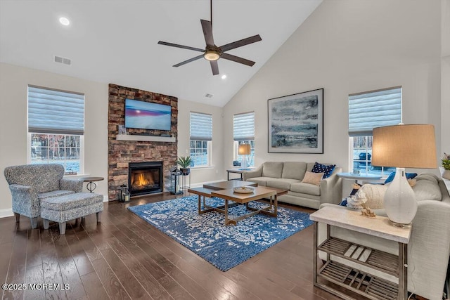 living room featuring dark hardwood / wood-style flooring, a wealth of natural light, and high vaulted ceiling