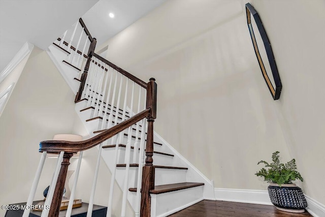 staircase with hardwood / wood-style floors