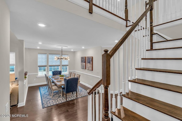 dining space with an inviting chandelier and dark hardwood / wood-style flooring