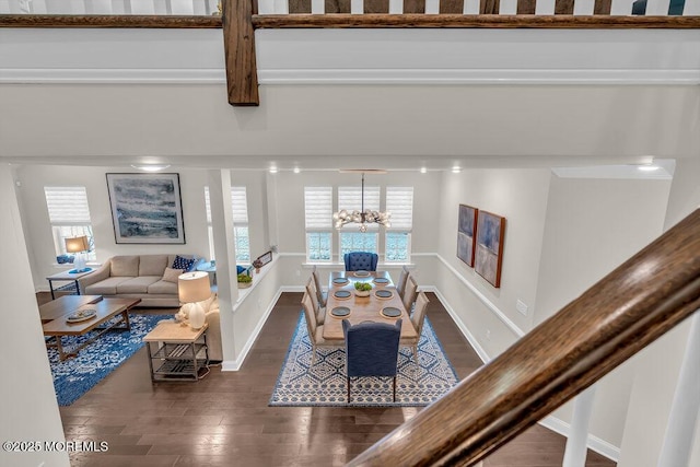 living room featuring dark wood-type flooring and an inviting chandelier