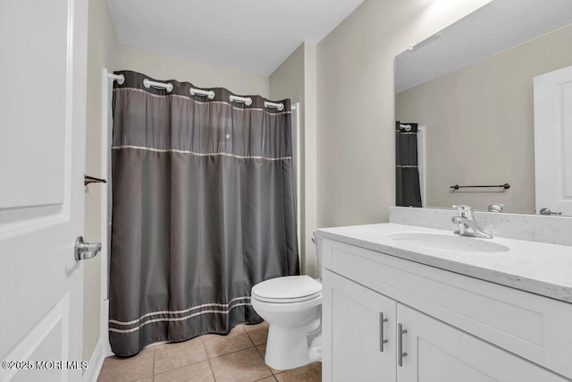 bathroom featuring vanity, tile patterned floors, and toilet