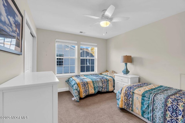 carpeted bedroom with a closet and ceiling fan