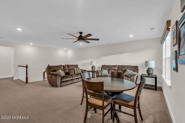 dining room featuring ceiling fan and light colored carpet