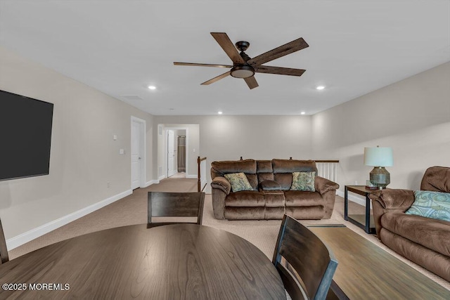 living room featuring light carpet and ceiling fan