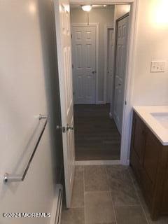 bathroom with baseboard heating, tile patterned floors, and vanity