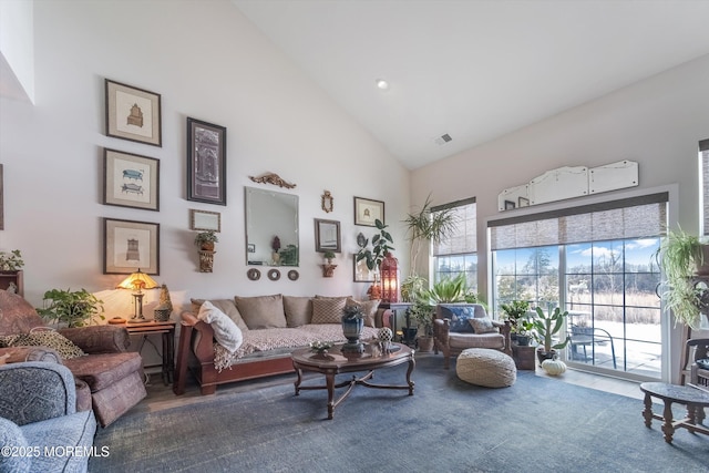 living room with high vaulted ceiling