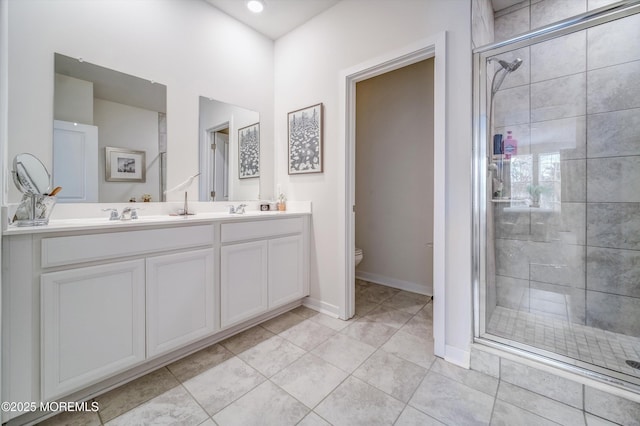 bathroom with vanity, tile patterned flooring, toilet, and walk in shower