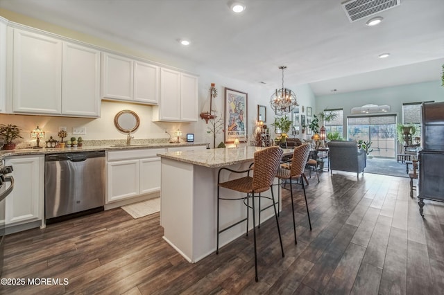 kitchen featuring a kitchen island, dark hardwood / wood-style floors, white cabinets, hanging light fixtures, and stainless steel dishwasher