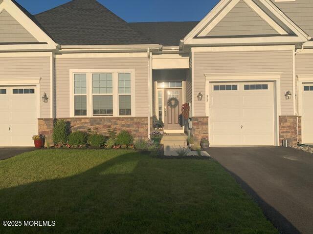 craftsman-style house with a garage and a front yard