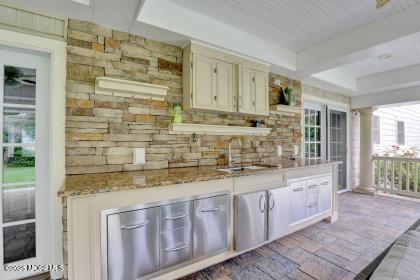 kitchen with light stone countertops and sink