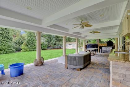 view of patio / terrace with sink, ceiling fan, and exterior kitchen