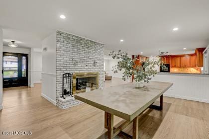 dining area featuring a fireplace and light hardwood / wood-style floors