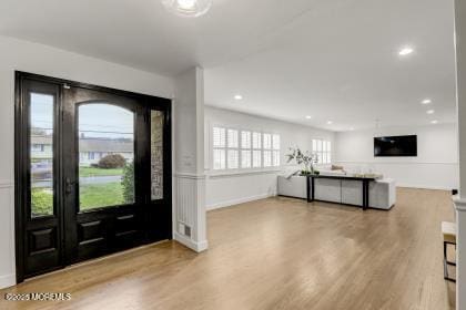 foyer entrance with light hardwood / wood-style flooring