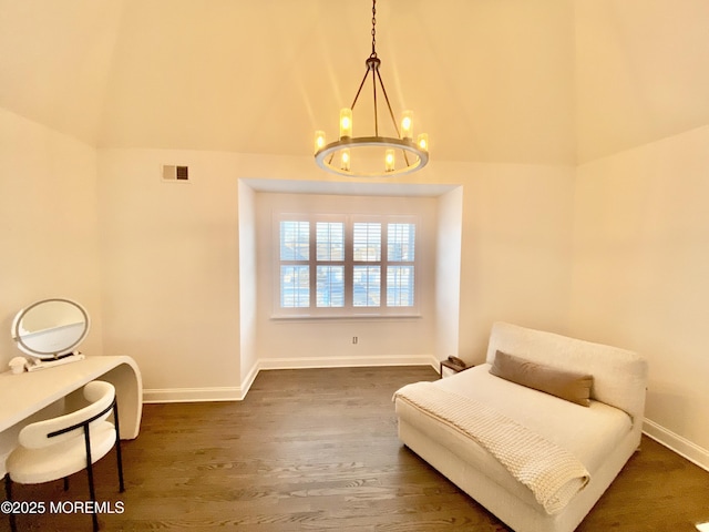 sitting room featuring dark hardwood / wood-style floors and a notable chandelier