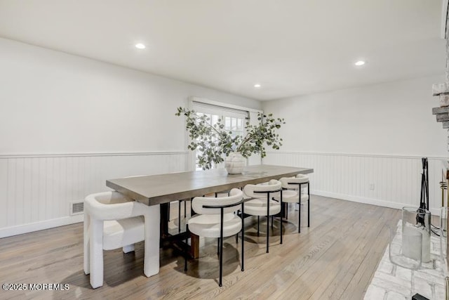 dining space with light hardwood / wood-style flooring