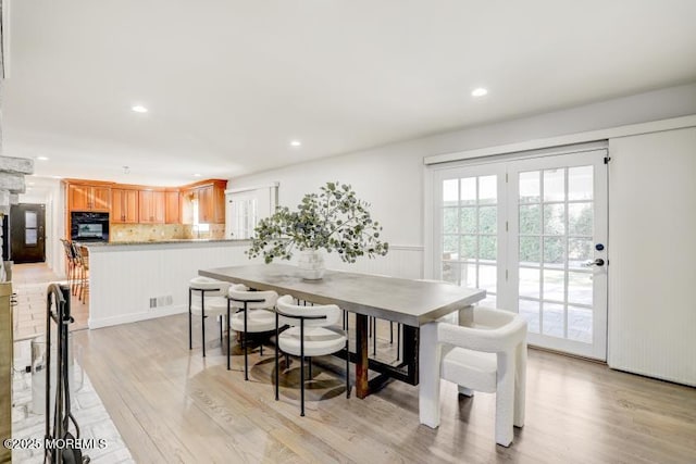 dining space featuring light wood-type flooring