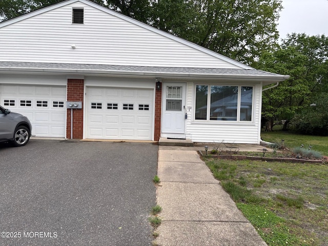 164 Columbine Ave Unit B, Manchester, NJ 08759 - view of front of home featuring a garage, brick siding, a shingled roof, and asphalt driveway