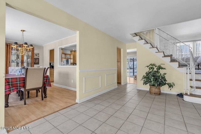 entryway featuring light tile patterned flooring and a chandelier