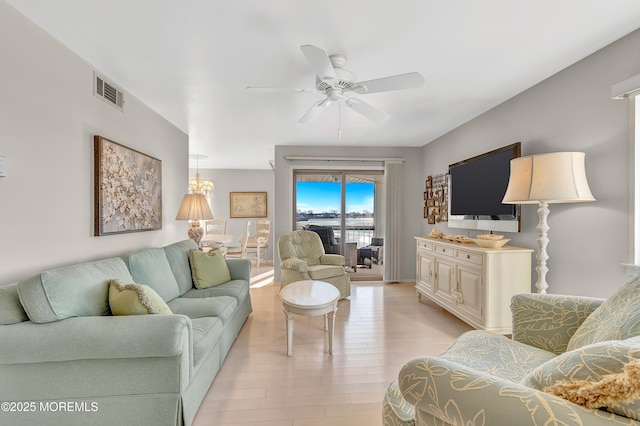 living room with ceiling fan and light hardwood / wood-style floors