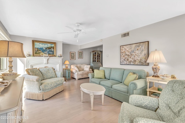 living room with ceiling fan and light wood-type flooring