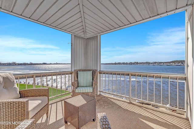 balcony with a beach view and a water view