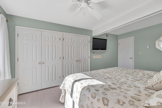 bedroom with multiple closets and ceiling fan