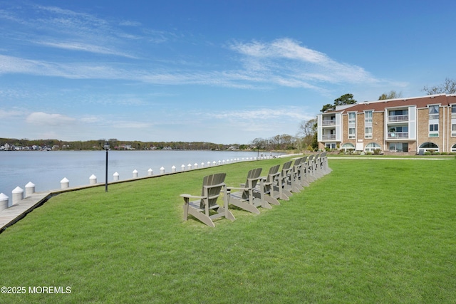 dock area featuring a yard and a water view