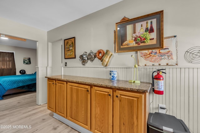 kitchen with light stone countertops and light wood-type flooring