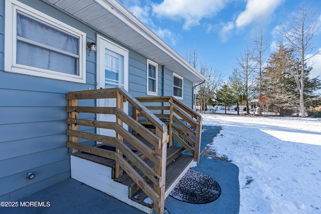 view of snow covered property entrance