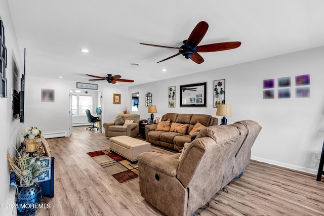 living room featuring ceiling fan, baseboard heating, and light hardwood / wood-style floors