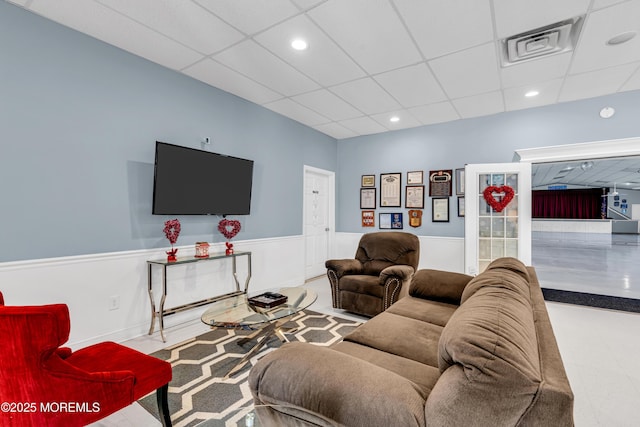 living room with a paneled ceiling