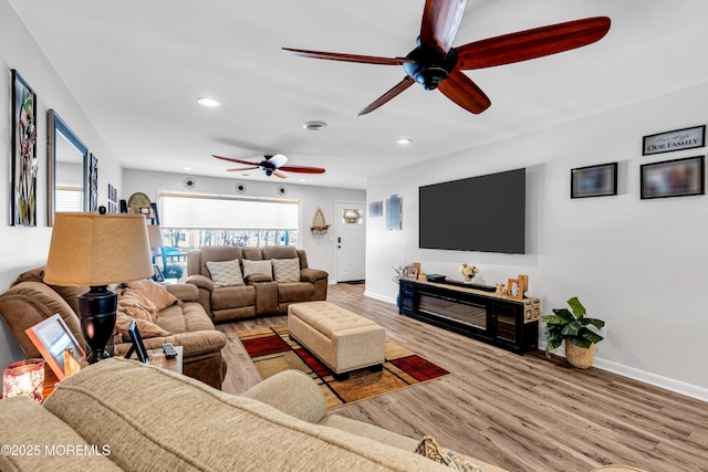 living room featuring ceiling fan and wood-type flooring