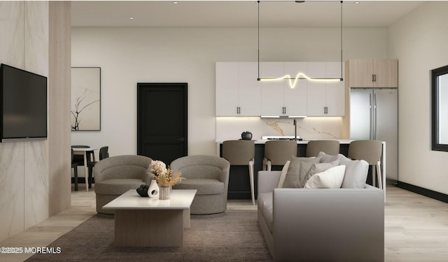 living area featuring baseboards and light wood finished floors